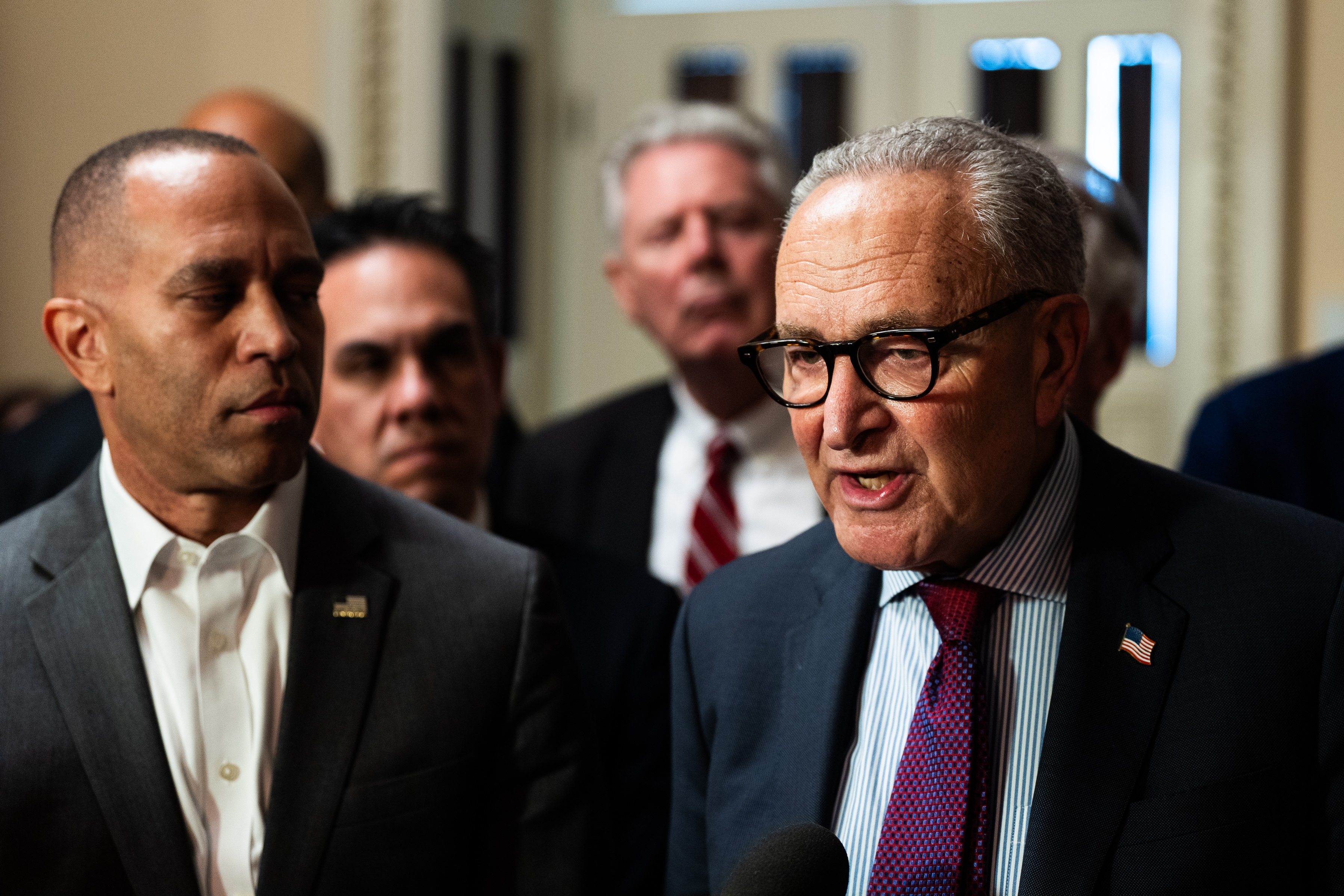 Senate Minority Leader Charles Schumer, right, and House Minority Leader Hakeem Jeffries speak with members of the press on Capitol Hill on Sept. 11. The two New York Democrats are asking President Trump for a meeting before an impending government shutdown.